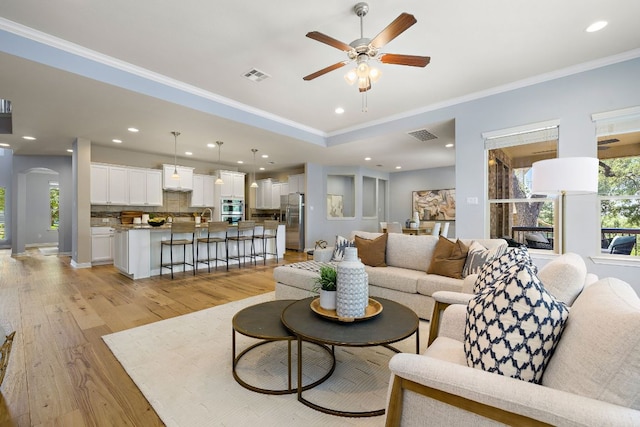 8317 Turning Trl, Austin, TX 78737 - living area with a ceiling fan, ornamental molding, light wood-type flooring, arched walkways, and recessed lighting