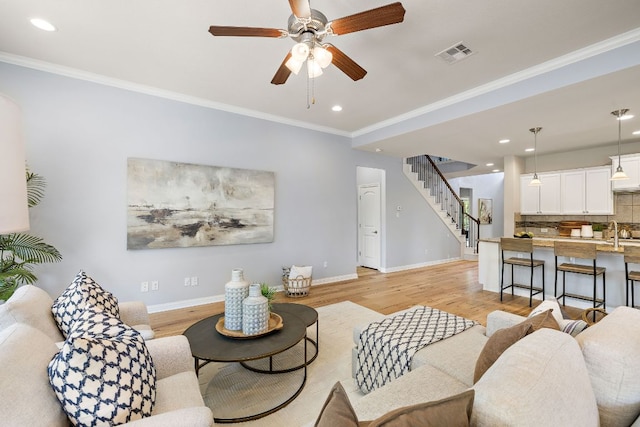 8317 Turning Trl, Austin, TX 78737 - living area featuring stairs, baseboards, light wood-style floors, recessed lighting, and crown molding