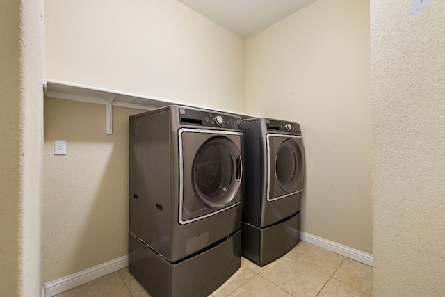 8317 Turning Trl, Austin, TX 78737 - clothes washing area featuring washer and clothes dryer, light tile patterned floors, and baseboards