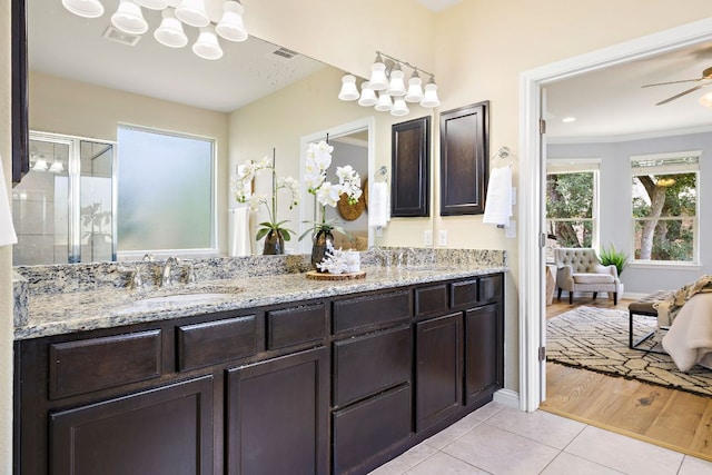 8317 Turning Trl, Austin, TX 78737 - bathroom with a chandelier, tile patterned flooring, a shower stall, ensuite bath, and double vanity