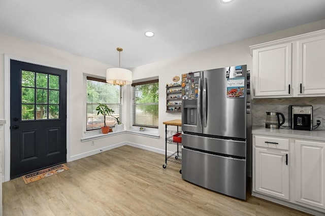 605 Galway Bay Cv, Pflugerville, TX 78660 - kitchen featuring stainless steel fridge, light countertops, baseboards, white cabinetry, and recessed lighting