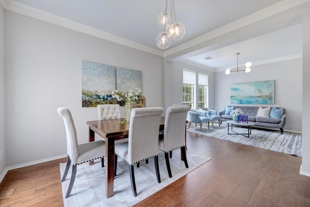 3831 Epperson Trl, Austin, TX 78732 - dining space with a chandelier, wood finished floors, crown molding, and baseboards
