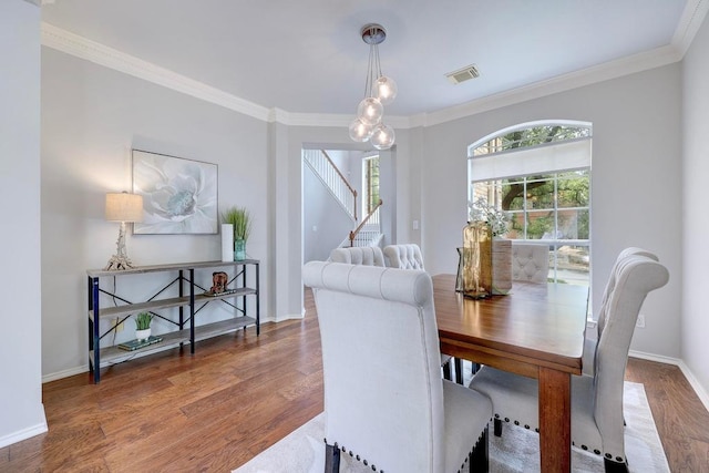 3831 Epperson Trl, Austin, TX 78732 - dining space with crown molding, wood finished floors, stairs, and baseboards