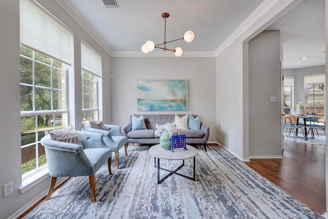 3831 Epperson Trl, Austin, TX 78732 - living area featuring wood finished floors, a chandelier, ornamental molding, and baseboards