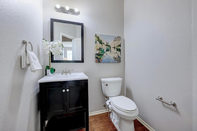3831 Epperson Trl, Austin, TX 78732 - half bath with wood finished floors, toilet, vanity, and baseboards