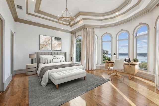 16010 Canard Cir, Austin, TX 78734 - bedroom featuring multiple windows, a chandelier, a water view, ornamental molding, and a raised ceiling
