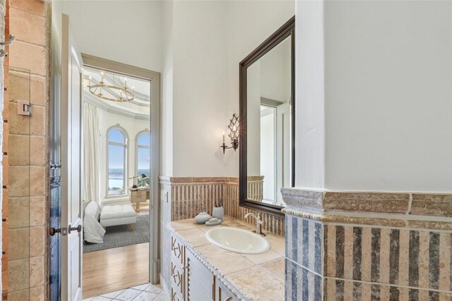 16010 Canard Cir, Austin, TX 78734 - bathroom featuring vanity, a wainscoted wall, and ensuite bath