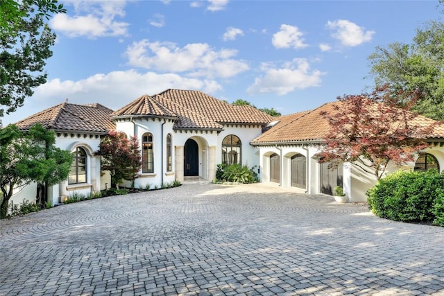 16010 Canard Cir, Austin, TX 78734 - mediterranean / spanish-style home with curved driveway, stucco siding, and a tile roof