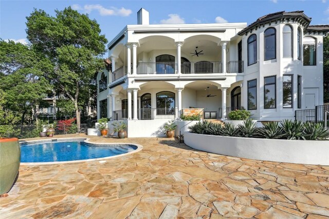 16010 Canard Cir, Austin, TX 78734 - back of house featuring a balcony, a ceiling fan, a patio, an outdoor pool, and stucco siding