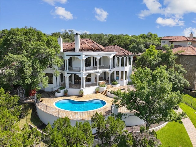16010 Canard Cir, Austin, TX 78734 - rear view of house featuring a balcony, a tile roof, a patio, and stucco siding