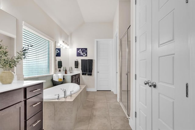 321 Millard St, Georgetown, TX 78628 - bathroom with vanity, a bath, a stall shower, tile patterned floors, and lofted ceiling