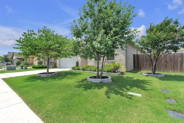 321 Millard St, Georgetown, TX 78628 - view of front of home with concrete driveway, an attached garage, and brick siding