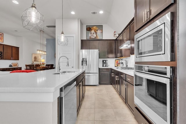321 Millard St, Georgetown, TX 78628 - kitchen with stainless steel appliances, dark brown cabinetry, light countertops, under cabinet range hood, and recessed lighting