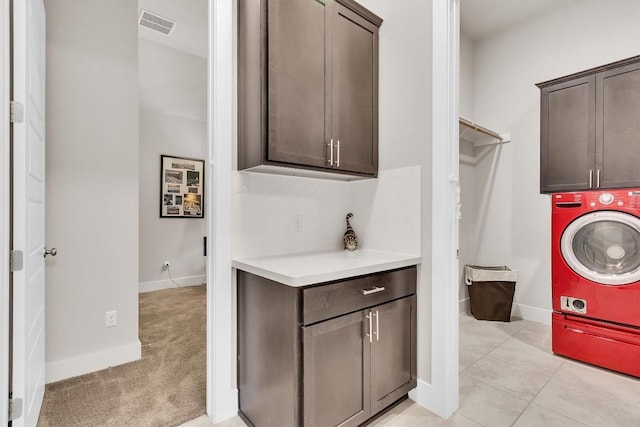 321 Millard St, Georgetown, TX 78628 - laundry area with cabinet space, washer / clothes dryer, and light colored carpet