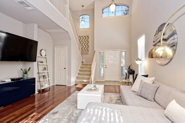 10312 Laredo Dr Unit 165, Austin, TX 78748 - living room with stairs, wood finished floors, a high ceiling, built in shelves, and baseboards