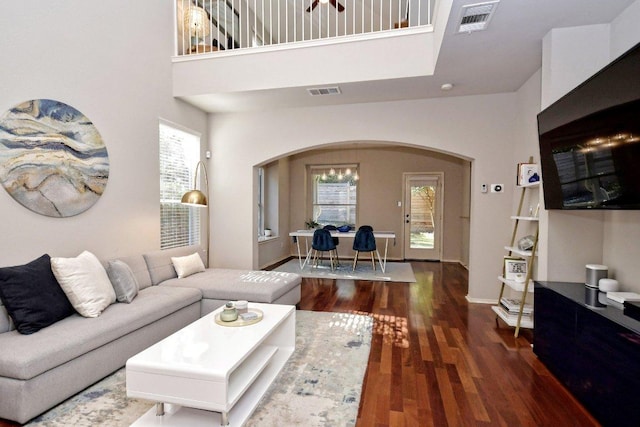 10312 Laredo Dr Unit 165, Austin, TX 78748 - living area featuring arched walkways, a towering ceiling, and wood finished floors