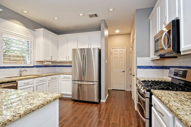 10312 Laredo Dr Unit 165, Austin, TX 78748 - kitchen with appliances with stainless steel finishes, white cabinetry, backsplash, and recessed lighting