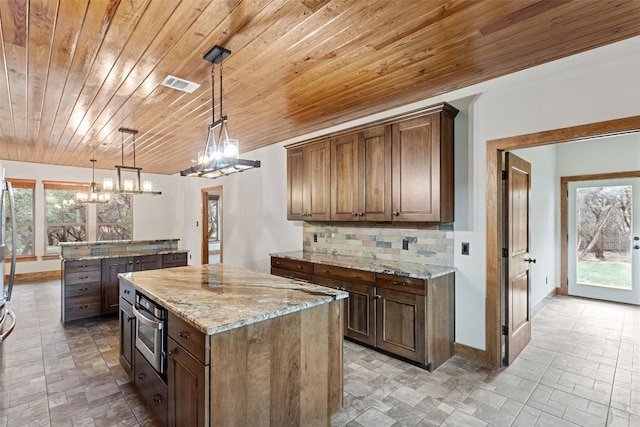 20603 Ridgeview Rd, Lago Vista, TX 78645 - kitchen with a center island, wood ceiling, decorative backsplash, a chandelier, and stainless steel oven