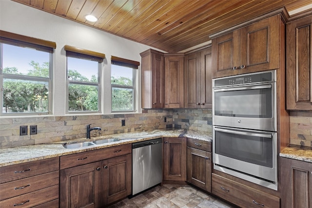 20603 Ridgeview Rd, Lago Vista, TX 78645 - kitchen with appliances with stainless steel finishes, backsplash, wood ceiling, light stone countertops, and light stone finish floors