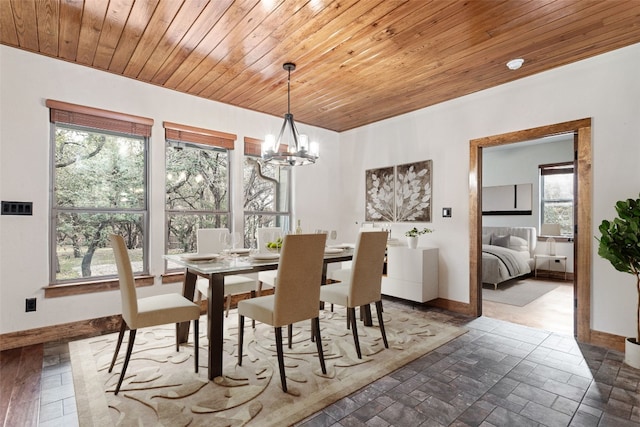 20603 Ridgeview Rd, Lago Vista, TX 78645 - dining area featuring a chandelier, healthy amount of natural light, wood ceiling, and stone tile flooring