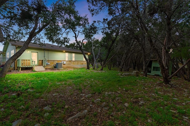 20603 Ridgeview Rd, Lago Vista, TX 78645 - yard at dusk featuring a lawn