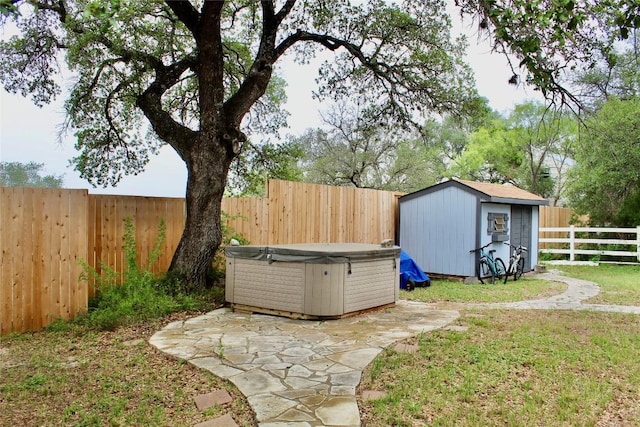 24701 Martin Ln, Spicewood, TX 78669 - fenced backyard with a hot tub, a storage shed, and a patio