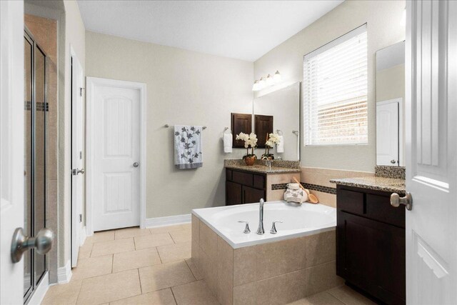5517 Brady Bayou Cv, Austin, TX 78738 - bathroom with a bath, vanity, tile patterned floors, and a stall shower