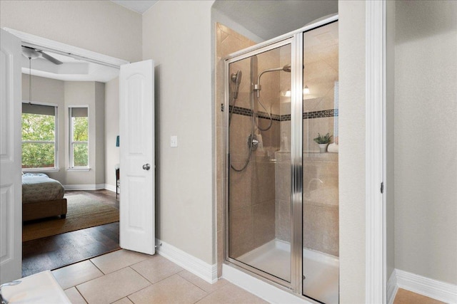 5517 Brady Bayou Cv, Austin, TX 78738 - ensuite bathroom with a shower stall, ceiling fan, and tile patterned floors