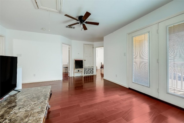 2718 Georgian Dr, Georgetown, TX 78626 - unfurnished living room with attic access, wood finished floors, ceiling fan, and baseboards