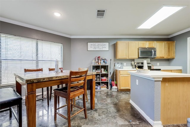 2718 Georgian Dr, Georgetown, TX 78626 - kitchen featuring stainless steel appliances, crown molding, light brown cabinetry, and light countertops