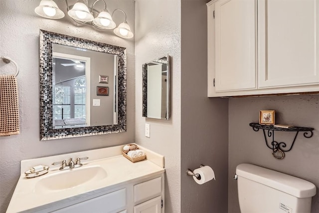 bathroom featuring toilet and vanity