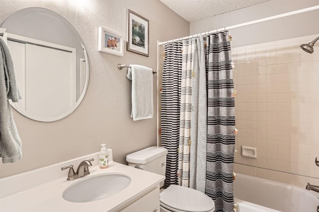 bathroom with toilet, shower / tub combo, vanity, and a textured ceiling