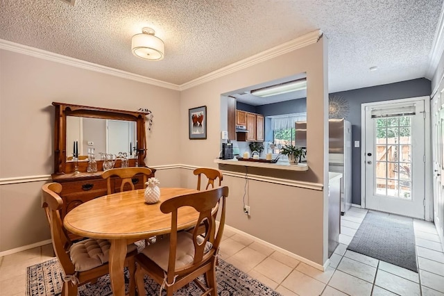 dining space featuring light tile patterned floors, a textured ceiling, baseboards, and crown molding