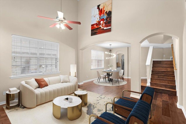 2502 Nightshade Dr, Cedar Park, TX 78613 - living area featuring arched walkways, a ceiling fan, wood finished floors, and a towering ceiling
