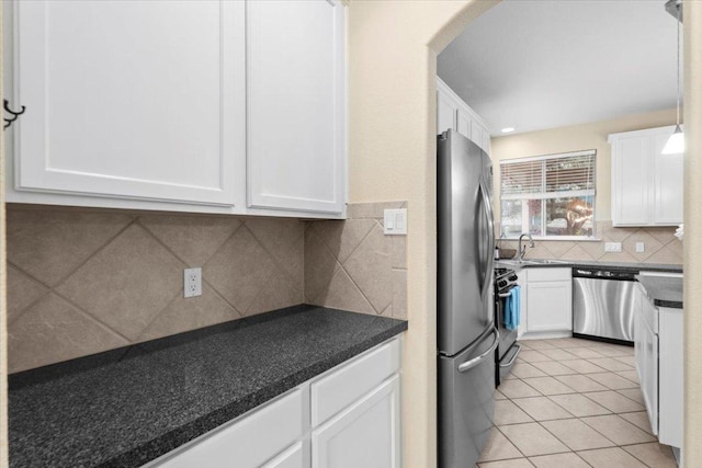 2502 Nightshade Dr, Cedar Park, TX 78613 - kitchen with stainless steel appliances, white cabinetry, backsplash, and dark countertops