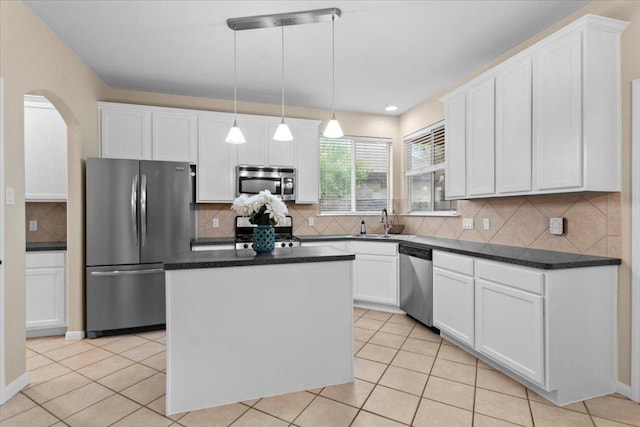 2502 Nightshade Dr, Cedar Park, TX 78613 - kitchen featuring appliances with stainless steel finishes, a kitchen island, white cabinetry, and dark countertops