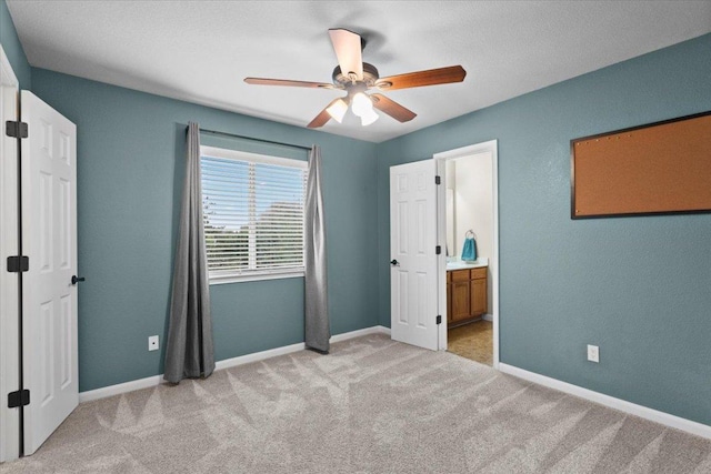 2502 Nightshade Dr, Cedar Park, TX 78613 - unfurnished bedroom with light carpet, baseboards, a ceiling fan, and ensuite bath
