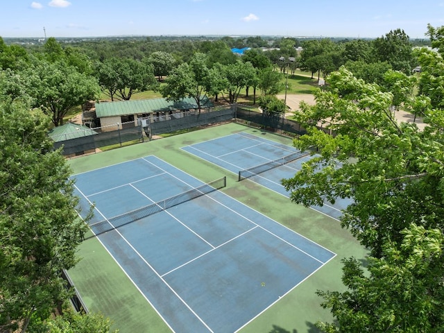 view of tennis court with fence