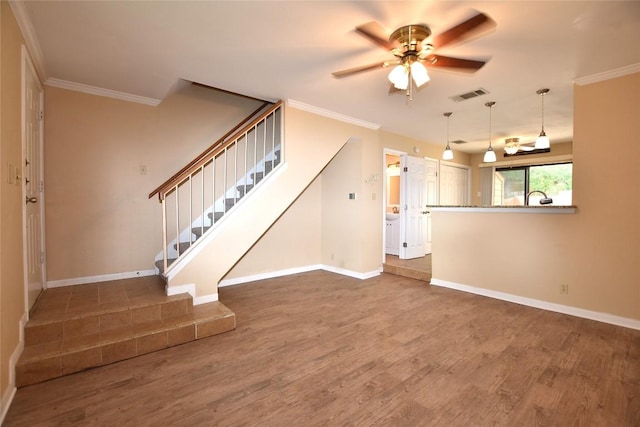 11404 Walnut Ridge Dr Unit 14, Austin, TX 78753 - unfurnished living room with wood finished floors, ceiling fan, stairway, baseboards, and ornamental molding