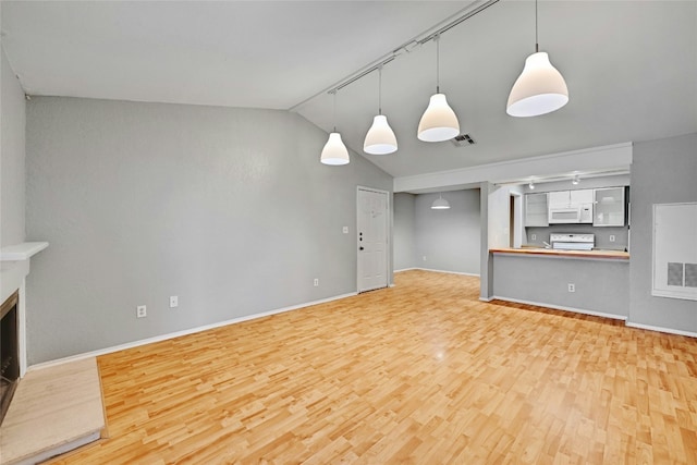 1202 Thorpe Ln Unit 508, San Marcos, TX 78666 - unfurnished living room with light wood-style flooring, lofted ceiling, baseboards, and track lighting