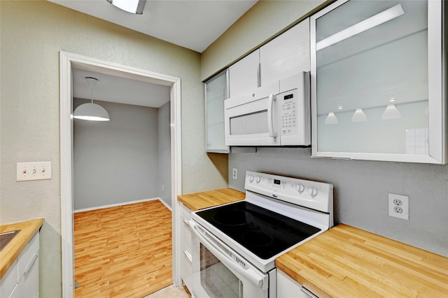 1202 Thorpe Ln Unit 508, San Marcos, TX 78666 - kitchen with white appliances, wooden counters, wood finished floors, and white cabinets