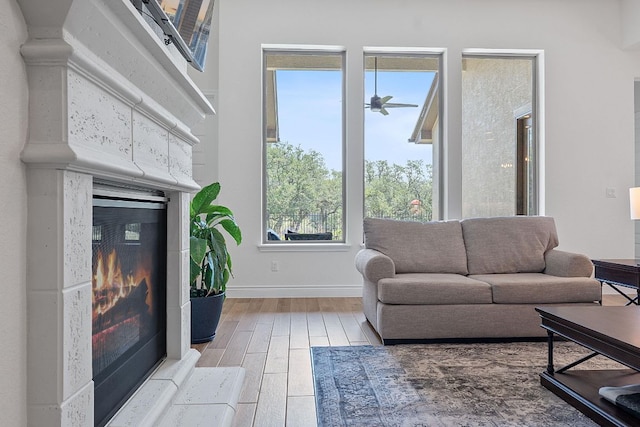 1437 Argyll Park, Bulverde, TX 78163 - living room featuring a glass covered fireplace, wood finished floors, baseboards, and ceiling fan