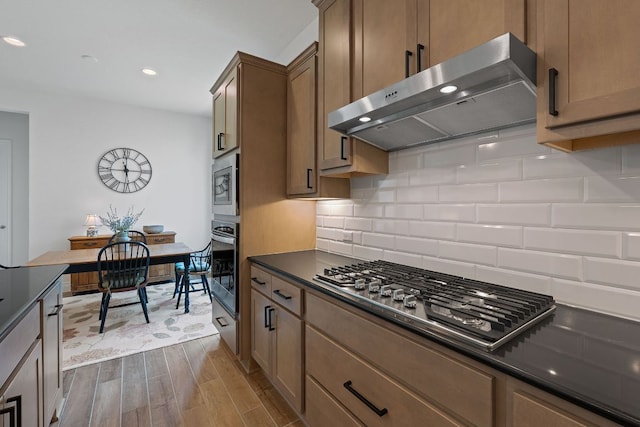 1437 Argyll Park, Bulverde, TX 78163 - kitchen with extractor fan, stainless steel appliances, dark countertops, dark wood-type flooring, and tasteful backsplash