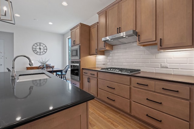 1437 Argyll Park, Bulverde, TX 78163 - kitchen featuring under cabinet range hood, stainless steel appliances, dark countertops, a sink, and tasteful backsplash