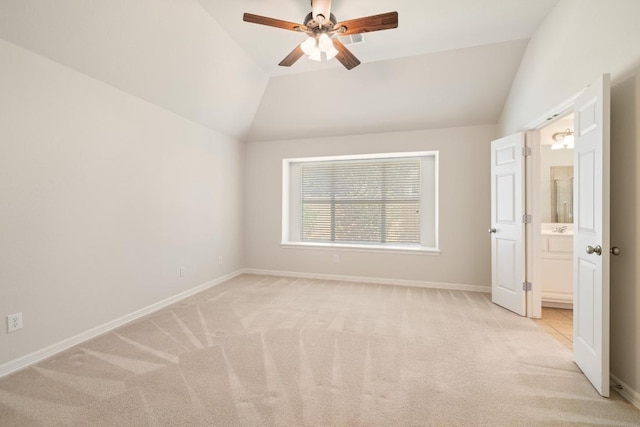 765 Bent Wood Pl, Round Rock, TX 78665 - unfurnished bedroom featuring light colored carpet, vaulted ceiling, baseboards, ceiling fan, and ensuite bathroom