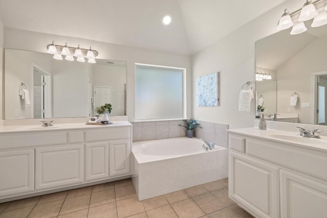 765 Bent Wood Pl, Round Rock, TX 78665 - bathroom featuring vaulted ceiling, tile patterned flooring, a garden tub, and two vanities