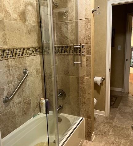 4003 Wyman Cv, Round Rock, TX 78681 - bathroom featuring bath / shower combo with glass door and toilet
