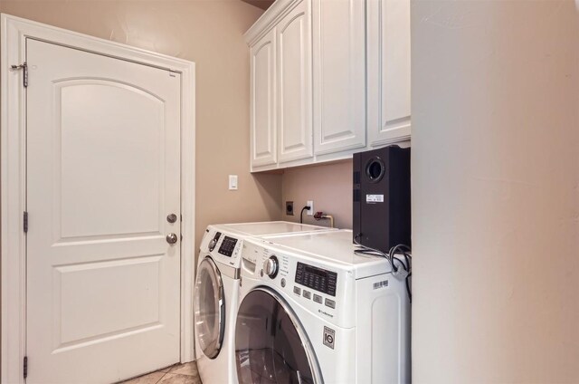 205 Sebastians Run, Austin, TX 78738 - washroom featuring cabinet space, washer and dryer, and light tile patterned flooring