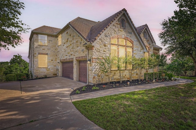 205 Sebastians Run, Austin, TX 78738 - view of front facade featuring stone siding, driveway, a front lawn, and a tiled roof
