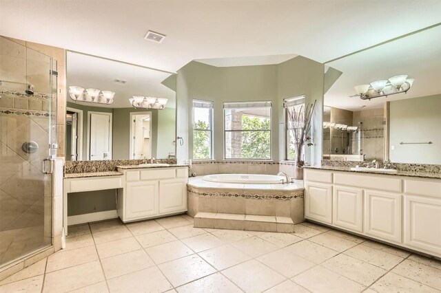 205 Sebastians Run, Austin, TX 78738 - bathroom featuring two vanities, a shower stall, a garden tub, and tile patterned floors